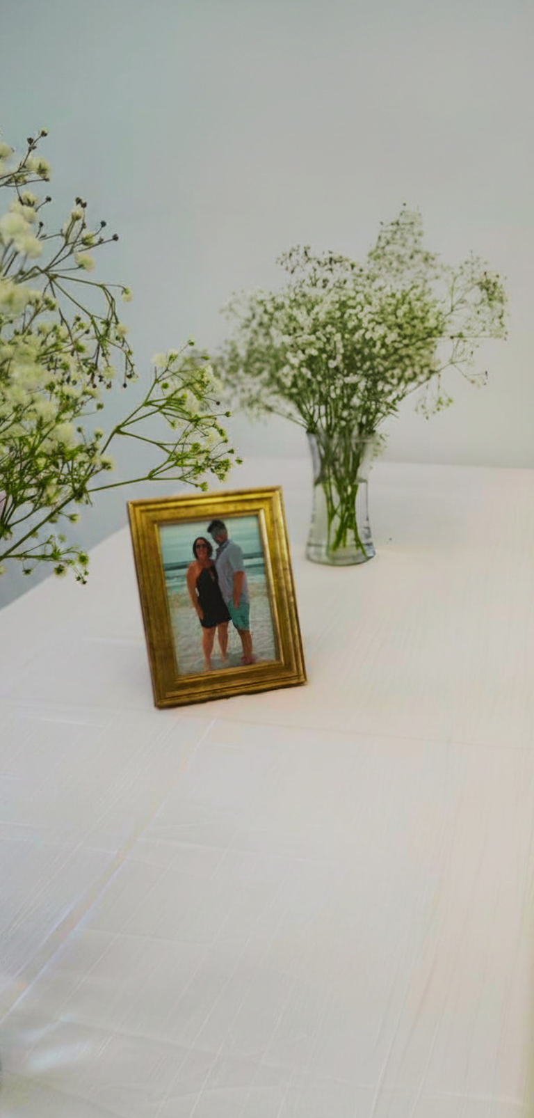 Gold-framed photo with baby's breath table décor