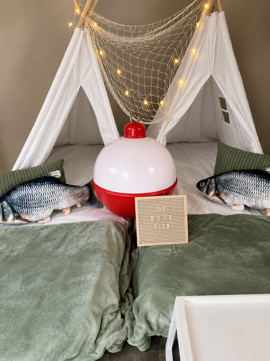 Boys Club fishing-themed tents with bobber lamp, fish pillows, and fishnet draping