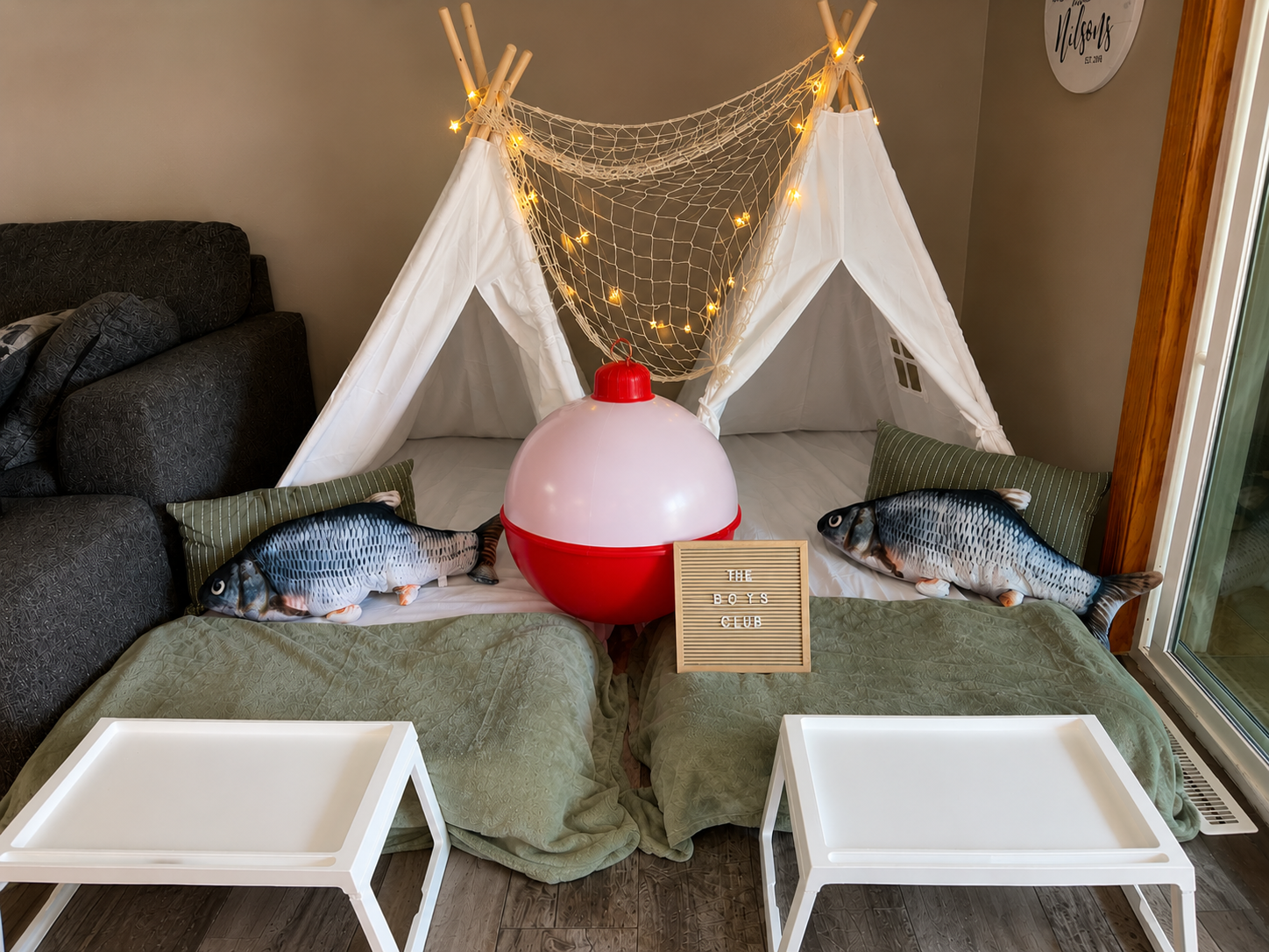 Fishing-themed sleepover with twin teepee tents, bobber lamp, and fish pillows